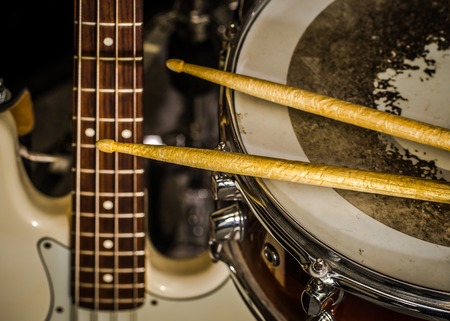 snare drum with drumsticks and bass guitar, closeup, concept musical composition and creativityの写真素材