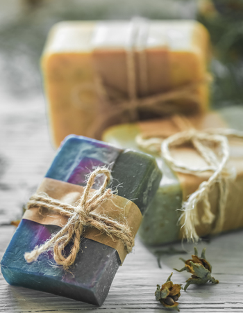 beautiful, fragrant handmade soap lies on a circular base on a wooden backgroundの写真素材