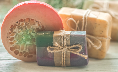beautiful, fragrant handmade soap lies on a circular base on a wooden backgroundの写真素材