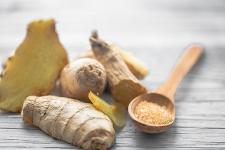 still life of fresh ginger with a wooden spoon  sugarの写真素材