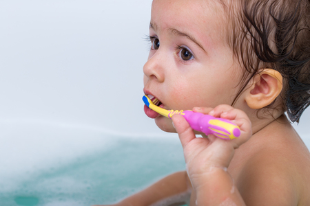 little cute girl bathing in the bathroom and brushing her teeth ,the pictures, the concept of hygiene and cleanlinessの写真素材