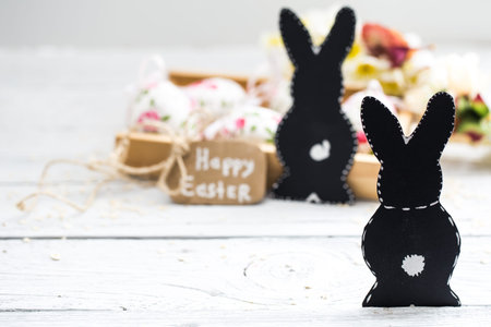 Easter composition with eggs and paper birds and with the inscription happy Easter is on a light...