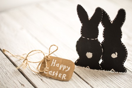 Easter bunnies on a light wooden background, holiday conceptの写真素材