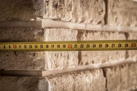 beautiful beige brick wall with centimeter ,background ,closeup , place for textの写真素材