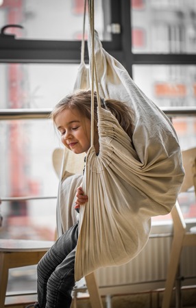 little girl on swing hammockの写真素材