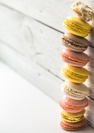 Multicolored macaroons on a beautiful wooden background ,concept of sweets and celebrationの写真素材