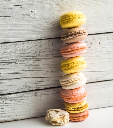 Multicolored macaroons on a beautiful wooden background ,concept of sweets and celebrationの写真素材