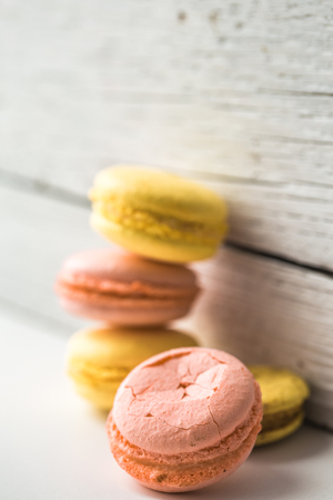 Multicolored macaroons on a beautiful wooden background ,concept of sweets and celebrationの写真素材