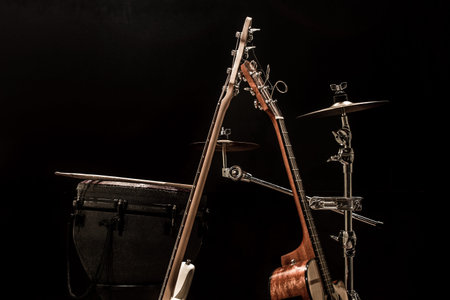 musical instruments, acoustic guitar and bass guitar and percussion instruments drums on a black background, the music conceptの写真素材