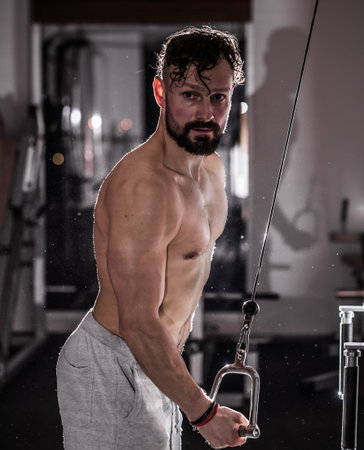 training cross fit in the gym,muscular man is at the gym,the concept of sport