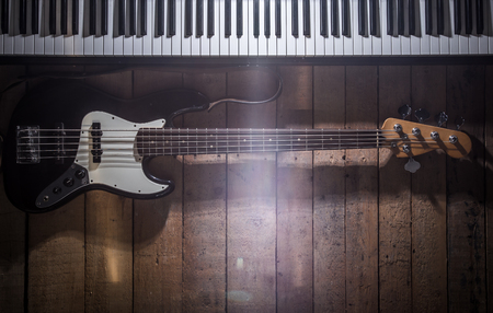 piano and guitar on wooden background closeup ,concept musical instrumentsの写真素材