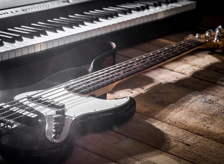 piano and guitar on wooden background closeup ,concept musical instrumentsの写真素材