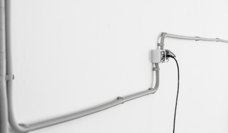 Electrician wire on the white walls,the concept of electricians and construction ,repairの写真素材