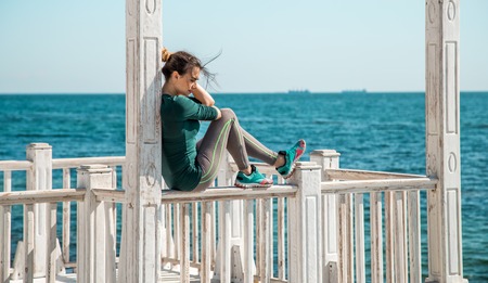 sporty girl on the pier doing exercises to do fitness ,sports motivation,sports,healthy lifestyleの写真素材