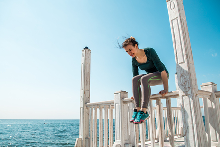 sporty girl on the pier doing exercises to do fitness ,sports motivation,sports,healthy lifestyleの写真素材