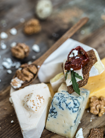 Different types of cheese on wooden background ,composition, delicatessen ,concept and gourmet cheesesの写真素材