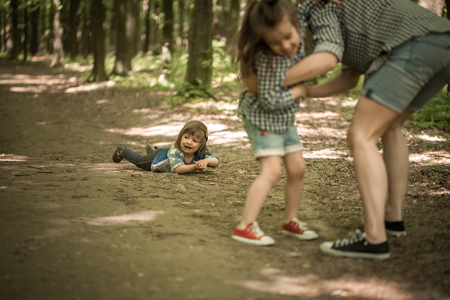 a young Mother with young daughters walk in the woods,the concept of family relations,mother's dayの写真素材