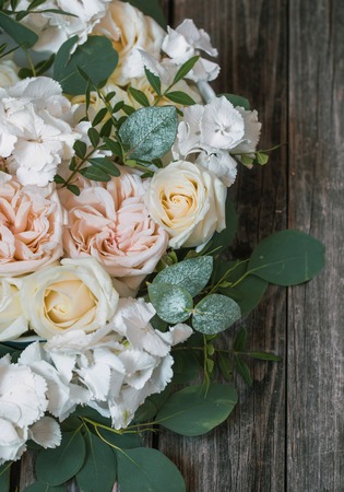 Floral arrangement of beautiful white roses on wooden background ,concept flowersの写真素材