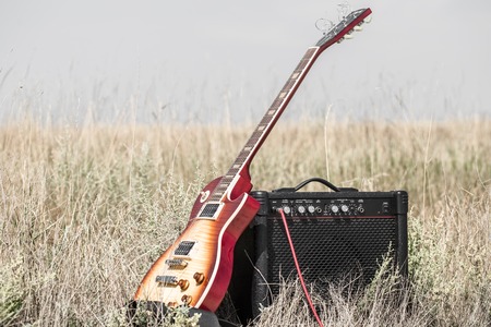 electric guitar and amp on the field, the concept of music and creativityの写真素材