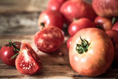 ripe Tomatoes on wooden background close-up ,concept farm vegetables and healthy eatingの写真素材