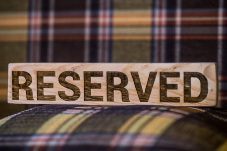 wooden sign saying reserved,close-up ,background ,concept hotels and restaurants