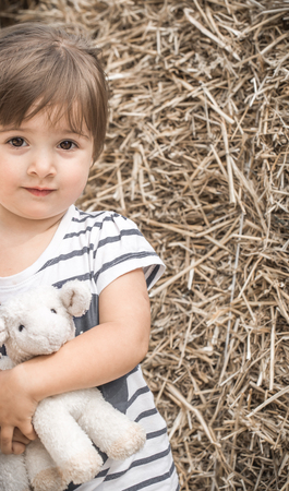 little girl with toy lambの写真素材