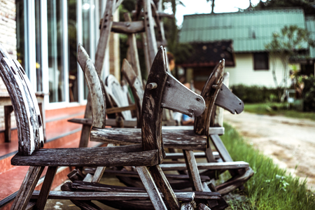 old children's wooden swing horse on the street in Thailandの写真素材