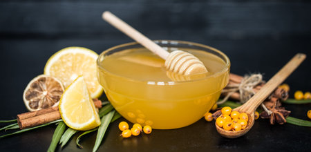 the composition of transparent plate with honey and lemon on a black background ,the concept of organic food and healthの写真素材