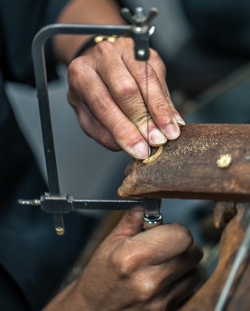 Thai jeweler, handles the jewelry and precious stones in the workshop, the process of jewelry making ,close-upの写真素材