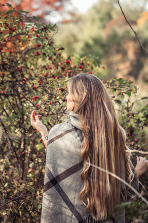 beautiful girl with long hair in autumn forest , autumn season conceptの写真素材