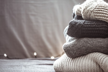 A stack of knitted sweaters ,the concept of warmth and comfort, hobby , background,closeupの写真素材