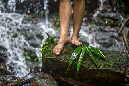 bare female feet on the stairs in the rainforest,the concept of relaxation and healthy lifestyleの写真素材