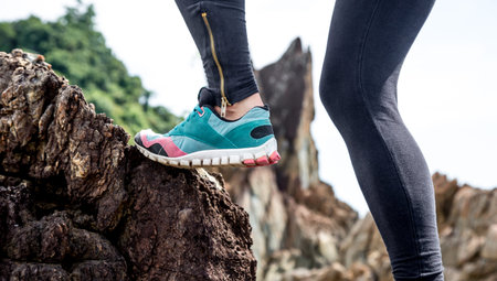 The girl in sportswear on the rocks , the concept of sports activity