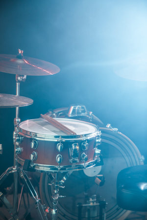 musical instruments drum kit, close-up, flash of light, a beautiful light in the background with...