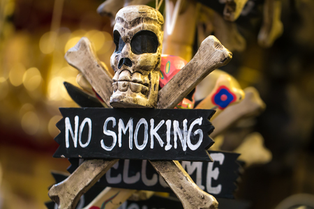 object with a skull and the inscription no smoke, closeupの写真素材