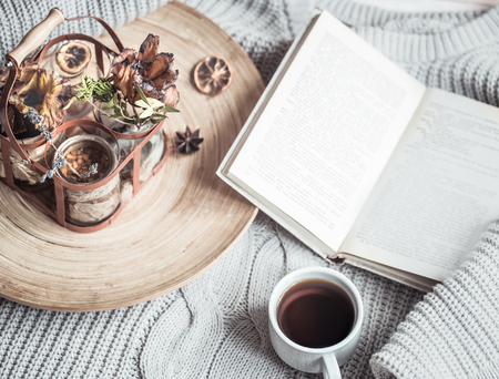 book with a cup of coffee on a wooden tray on the bed in the home interiorの写真素材
