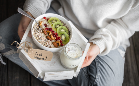 healthy breakfast at the girl in hands, concept of healthy foodの写真素材