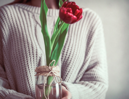 Girl with tulip in hands, concept of spring and female holidayの写真素材