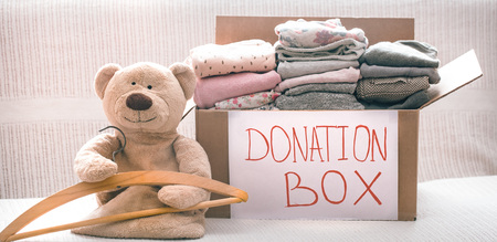 Box with clothes for charity, concept of social projects