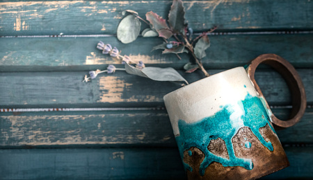 Original creative cup with flowers on a wooden backgroundの写真素材