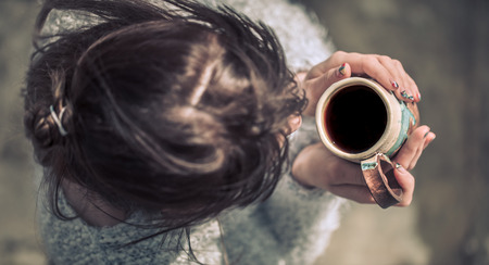 girl with a cup in hands, the concept of hot drinksの写真素材