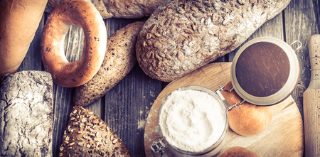 diverse fresh bread on a beautiful wooden background, concept of healthy eating and baking industryの写真素材