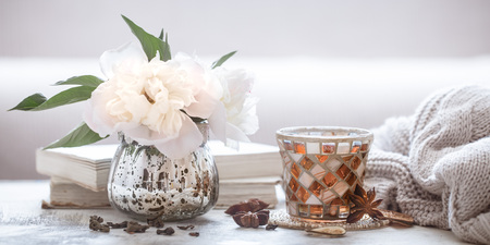 still life with interior details and flowers with peonies in the living room, the concept of home comfort and interiorの写真素材