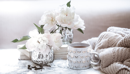 still life with interior details and flowers with peonies in the living room, the concept of home comfort and interiorの写真素材