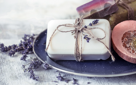 Spa still life with lavender and soap on a beautiful plate on a light background, space for textの写真素材