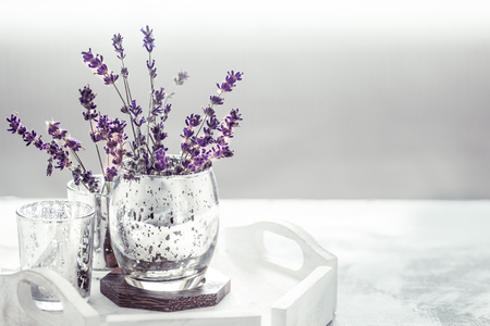 composition with lavender in a beautiful glass on the table in the living room, the concept of home comfortの写真素材