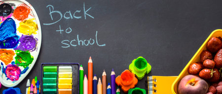 Back to school, school supplies on a black background, the concept of education and school life