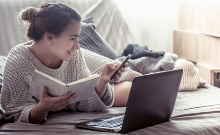 Girl at home at computer, concept of work at home, educationの写真素材