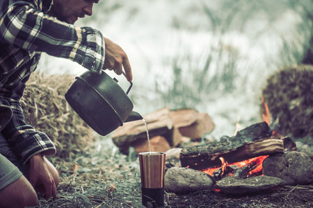 the concept of camping the guy on the nature of the fire with tourist facilities