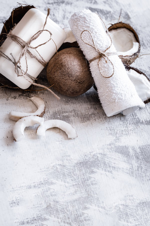 Spa still life of organic cosmetics with coconuts on a light wooden background, body care conceptの写真素材